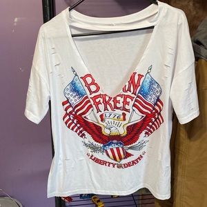 White T-shirt with a cut out on the chest and holes through out